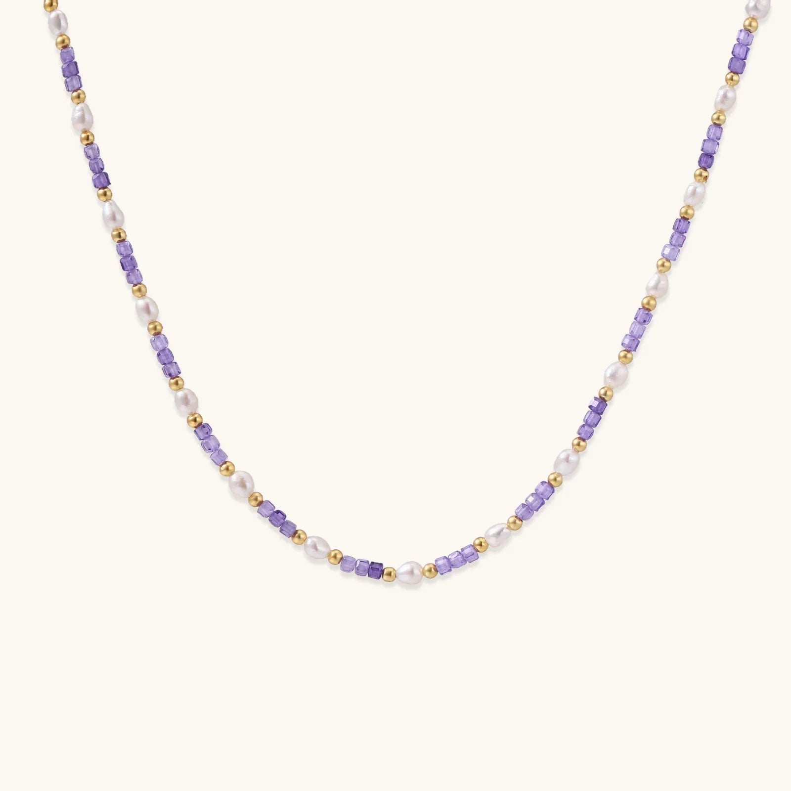 Delicate 18K gold vermeil necklace with alternating lavender zirconia beads and white freshwater pearls on cream background