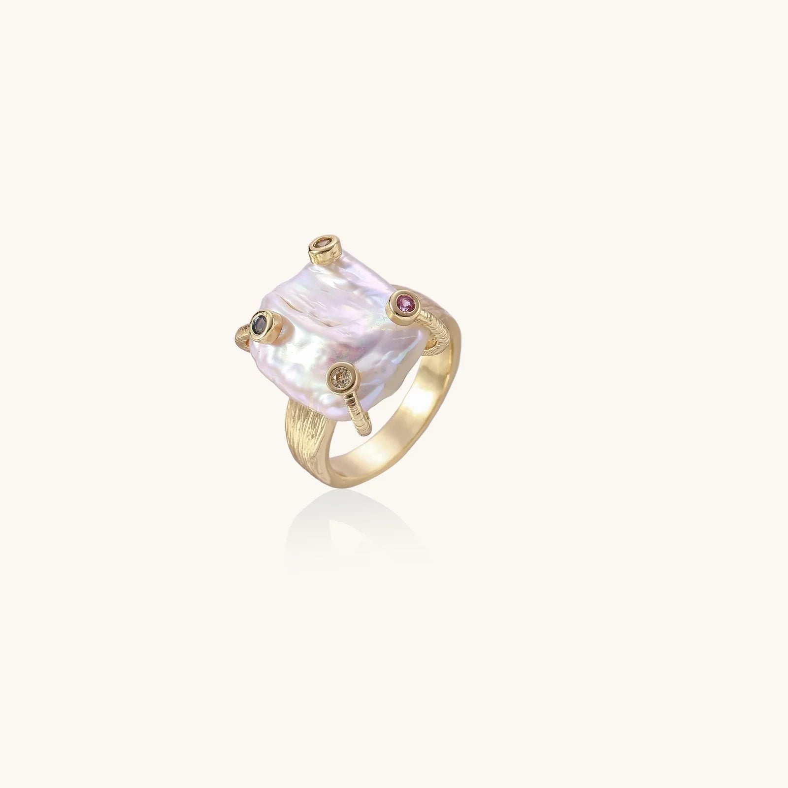 Gold ring with large iridescent baroque pearl and four colored gemstones on textured band